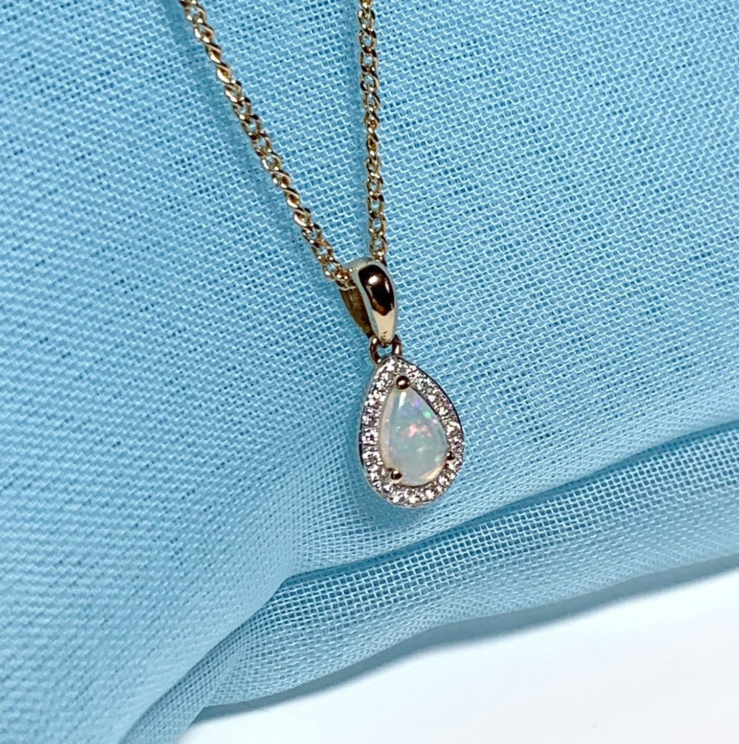 Teardrop shaped opal and diamond yellow gold cluster necklace