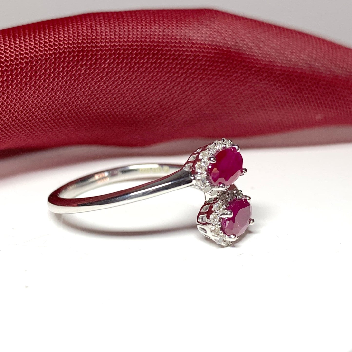 Crossover twist ruby diamond oval double cluster ring white gold