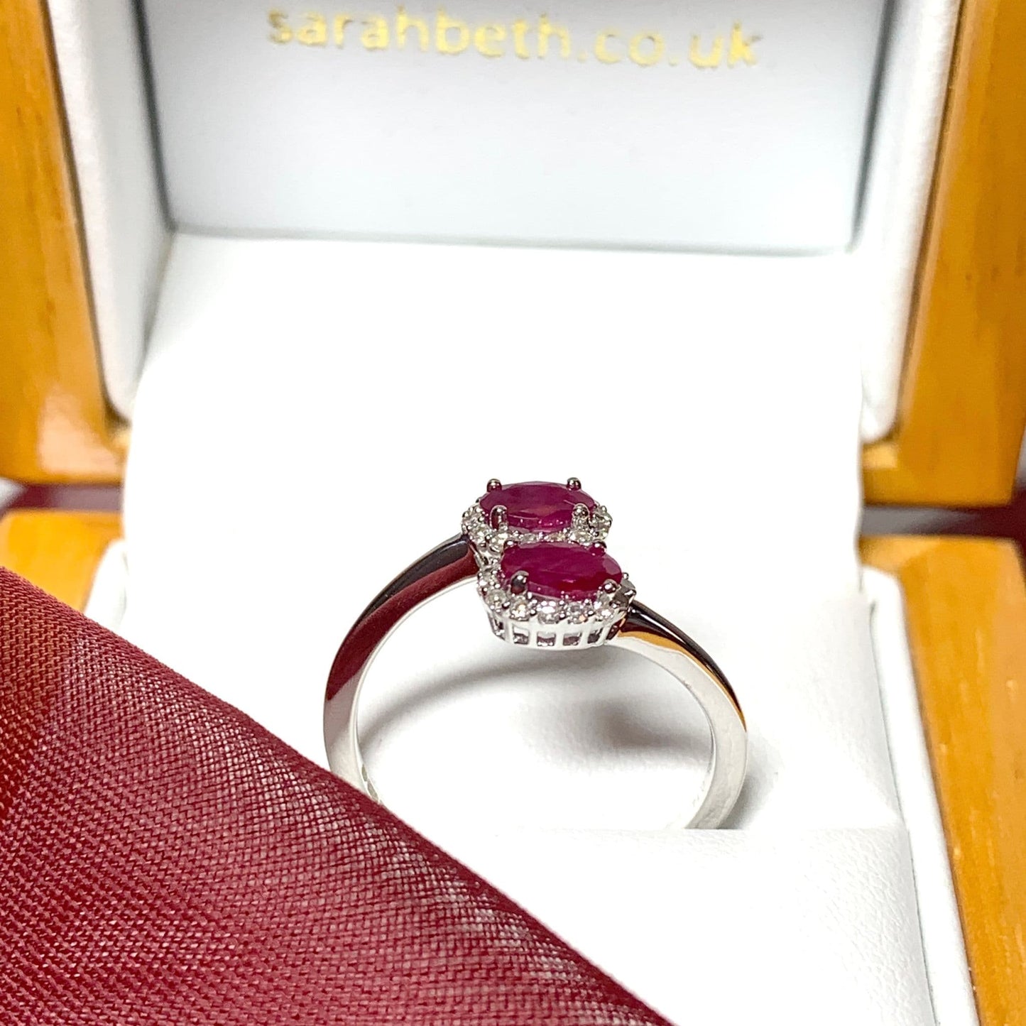 Crossover twist ruby diamond oval double cluster ring white gold