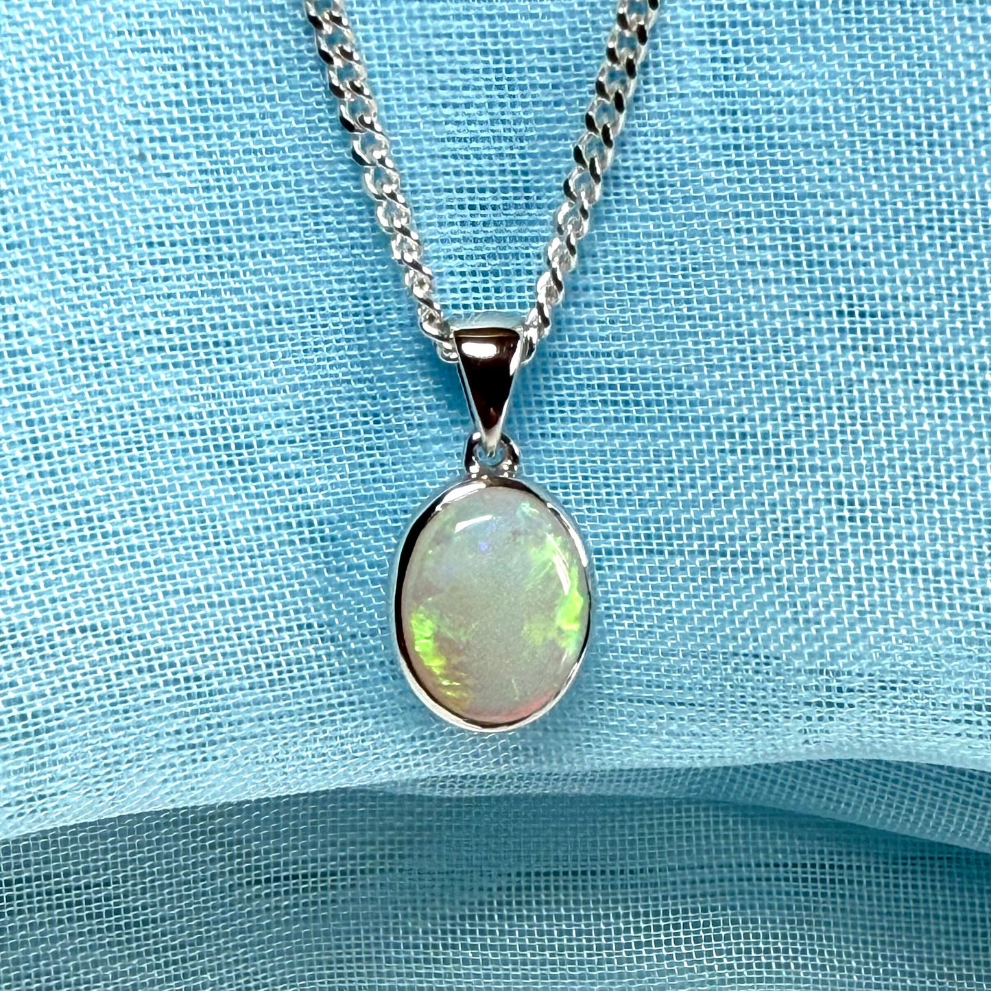 White gold real oval opal pendant rubbed over necklace with chain