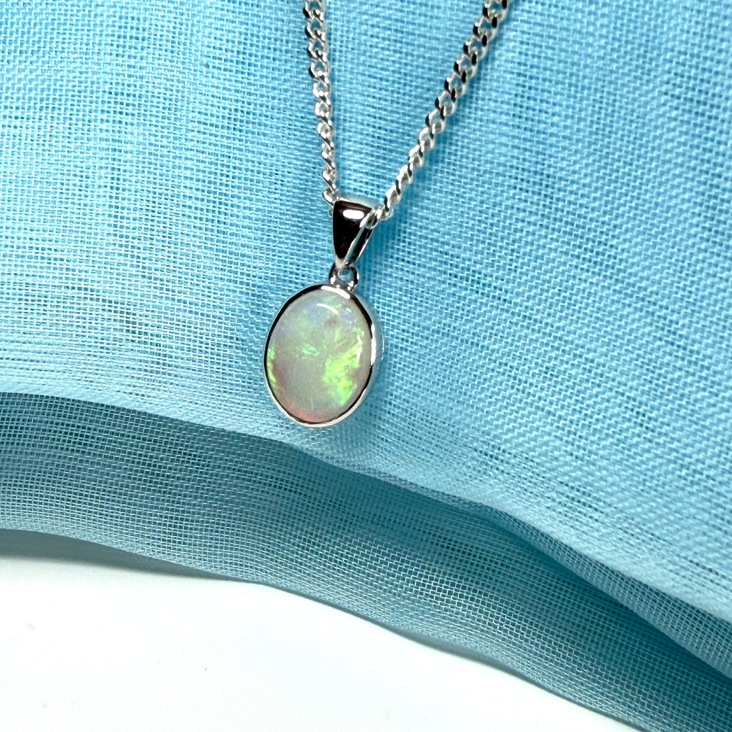 White gold real oval opal pendant rubbed over necklace with chain