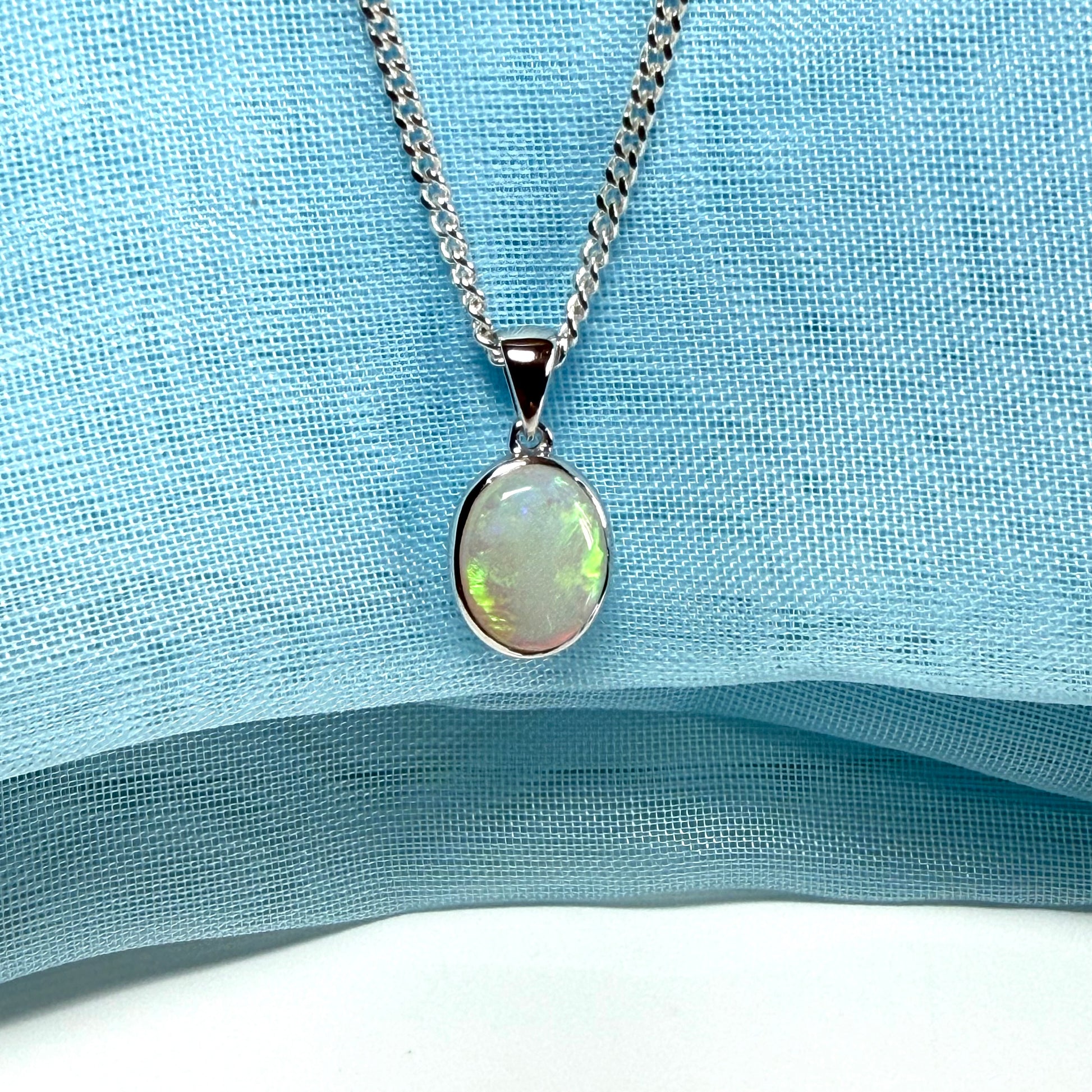 White gold real oval opal pendant rubbed over necklace with chain