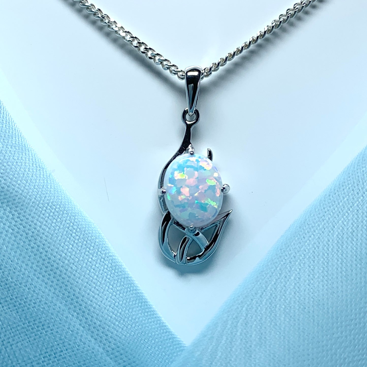 White gold celtic design oval opal necklace