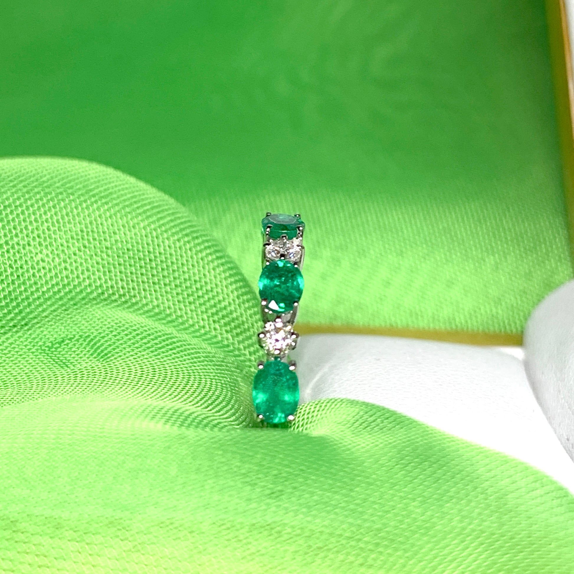 White gold oval green real emerald and diamond eternity ring