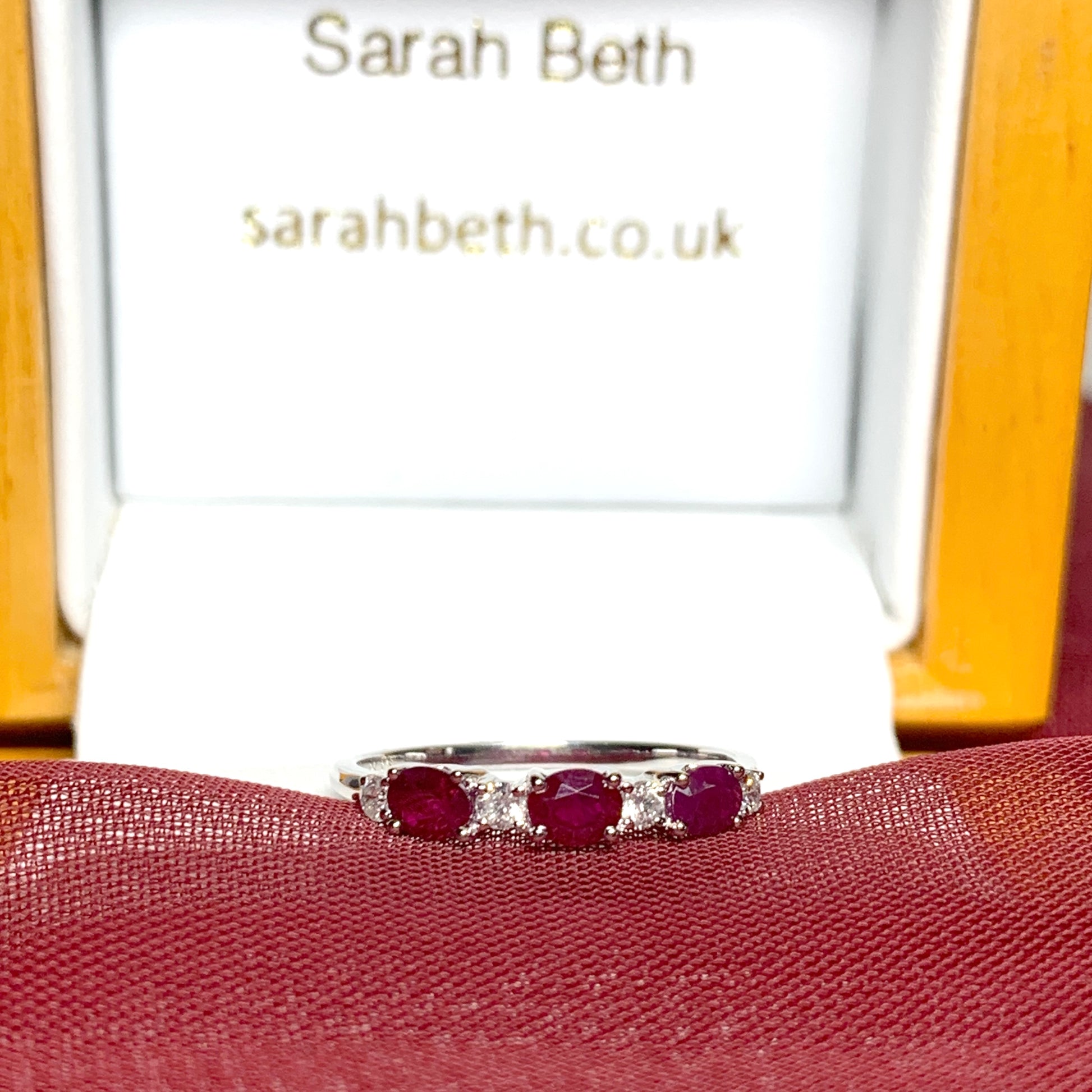 White gold oval ruby and diamond eternity ring