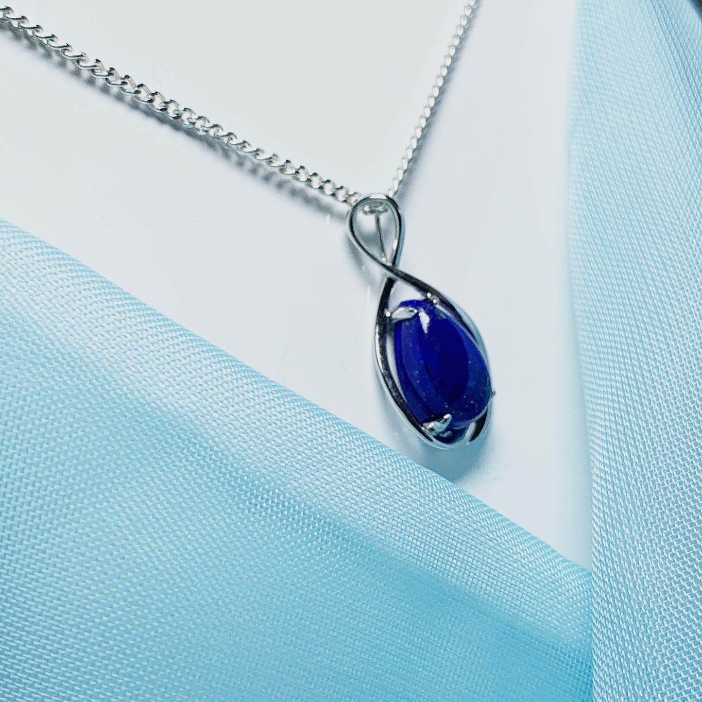 White gold pear teardrop shaped blue lapis lazuli necklace pendant