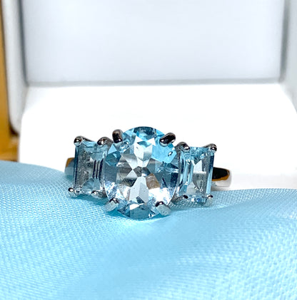 Blue topaz trilogy three stone dress ring white gold