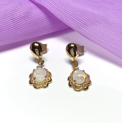 Yellow gold real opal oval drop earrings with a fancy edging