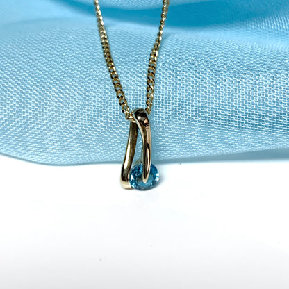 Yellow gold blue topaz necklace pendent