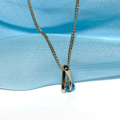 Yellow gold blue topaz necklace pendent