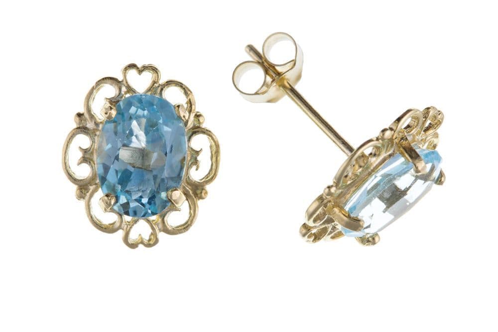 Yellow gold oval shaped blue topaz stud earrings