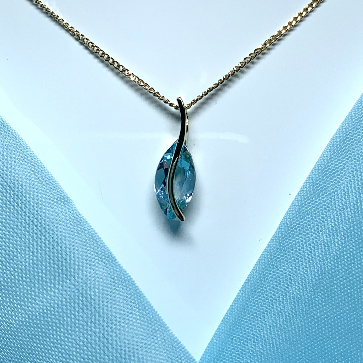 Yellow gold real blue topaz fancy swirl marquise shaped necklace pendent