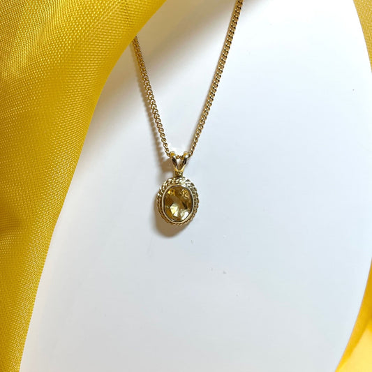 An oval yellow gold citrine necklace
