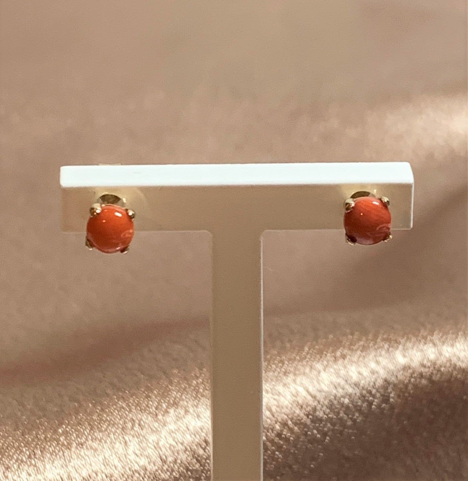 Dark round coral yellow gold claw set stud earrings