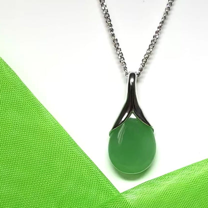 A real green jade necklace in a teardrop or pear shaped including a chain and a gift box