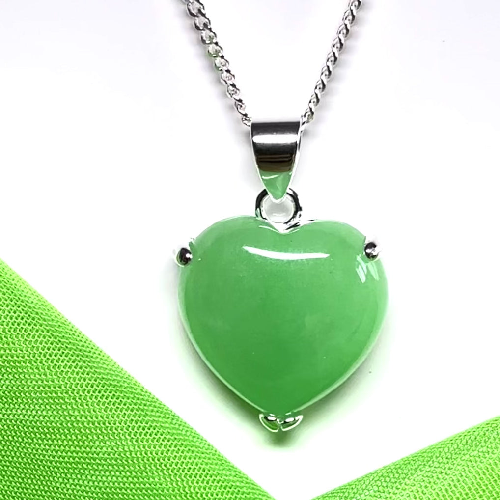 A green real jade pendant necklace heart shape sterling silver with a chain included