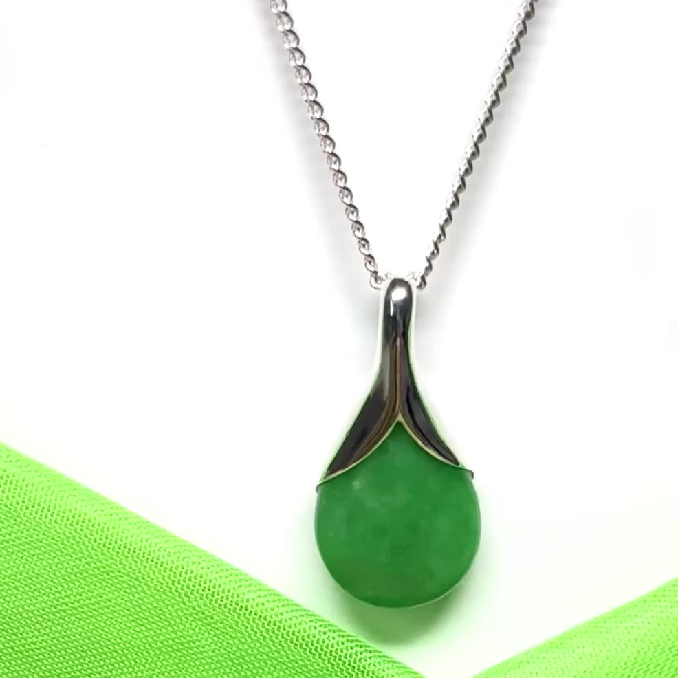 A stunning real green jade necklace in a teardrop or a pear shape including a solid chain