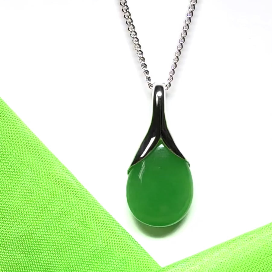 A real green jade pear shaped necklace in a teardrop pendant with a chain included