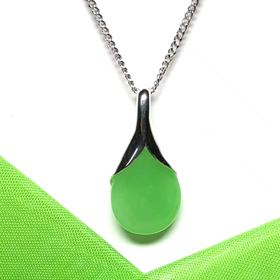 A really stunning real green jade necklace in a teardrop or a pear shape including a solid curb chain