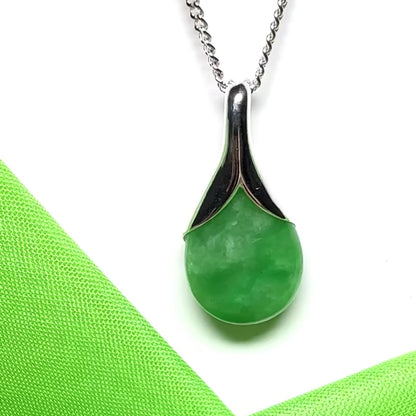 A real green jade necklace in a teardrop or a pear shape including a solid curb chain