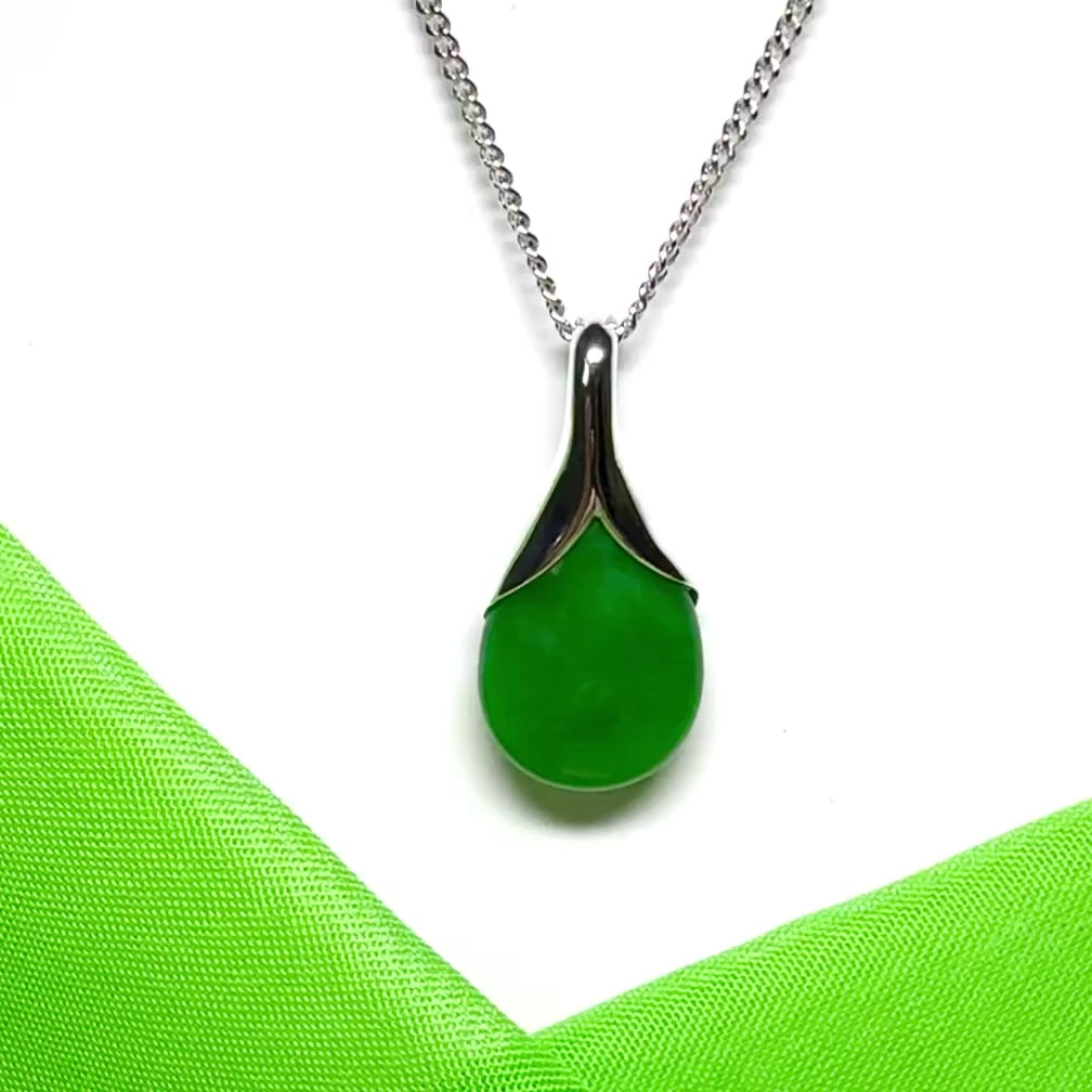 A real green jade necklace in a teardrop or pear shaped