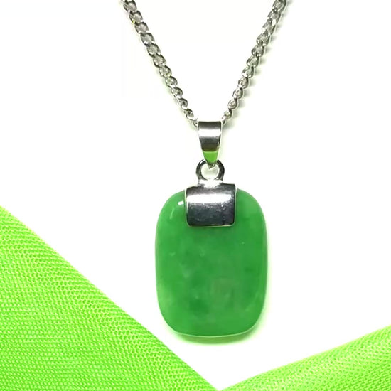 A stunning sterling silver cushion shaped real green jade necklace pendant with a solid curb chain included