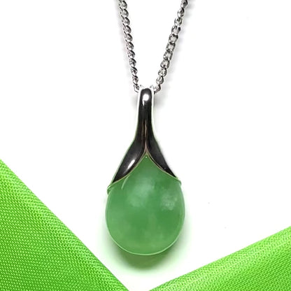 A real green jade pear shape necklace in a teardrop pendant with a chain included