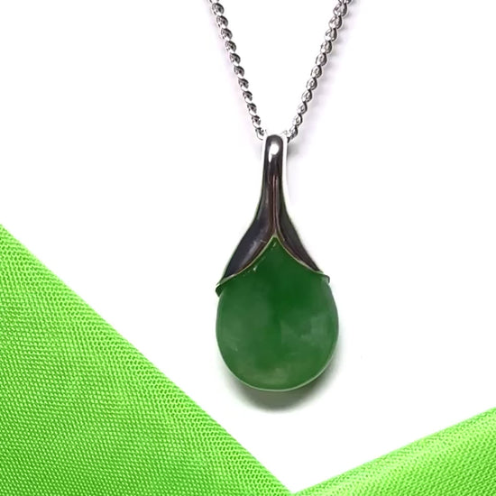 A real green jade necklace teardrop with a pear shaped pendant, with chain included