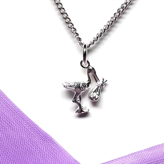 Stork carrying a baby necklace sterling silver charm pendant