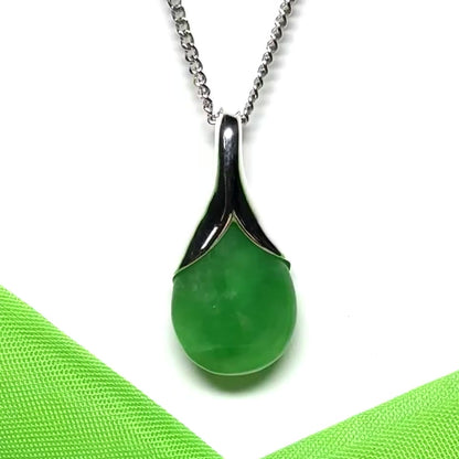 A real green jade necklace in a teardrop or a pear shape including a chain