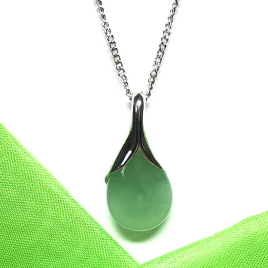 A real green jade necklace in a teardrop or a pear shape including a solid chain