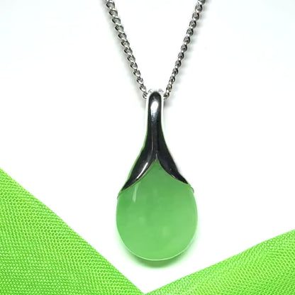 A stunning real green jade necklace in a teardrop or a pear shape including a solid curb chain