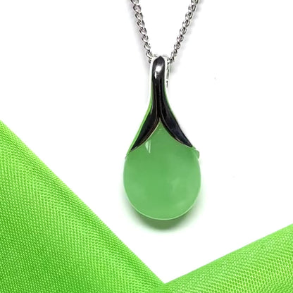 A real green jade necklace in a teardrop or pear shaped including a chain