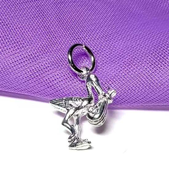 Stork carrying a baby small sterling silver charm