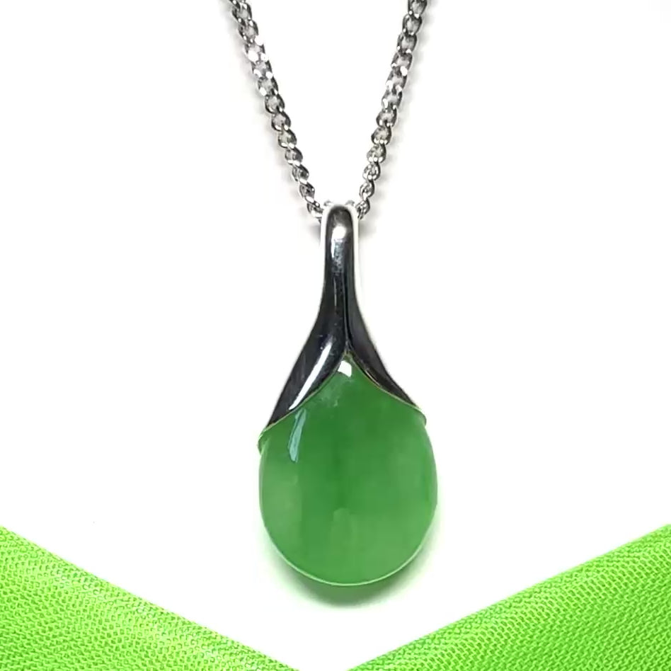 A real green jade pendant necklace in a teardrop shaped or pear shaped design