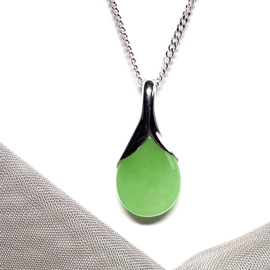 A real green jade pendant necklace in a teardrop shape or pear shaped design