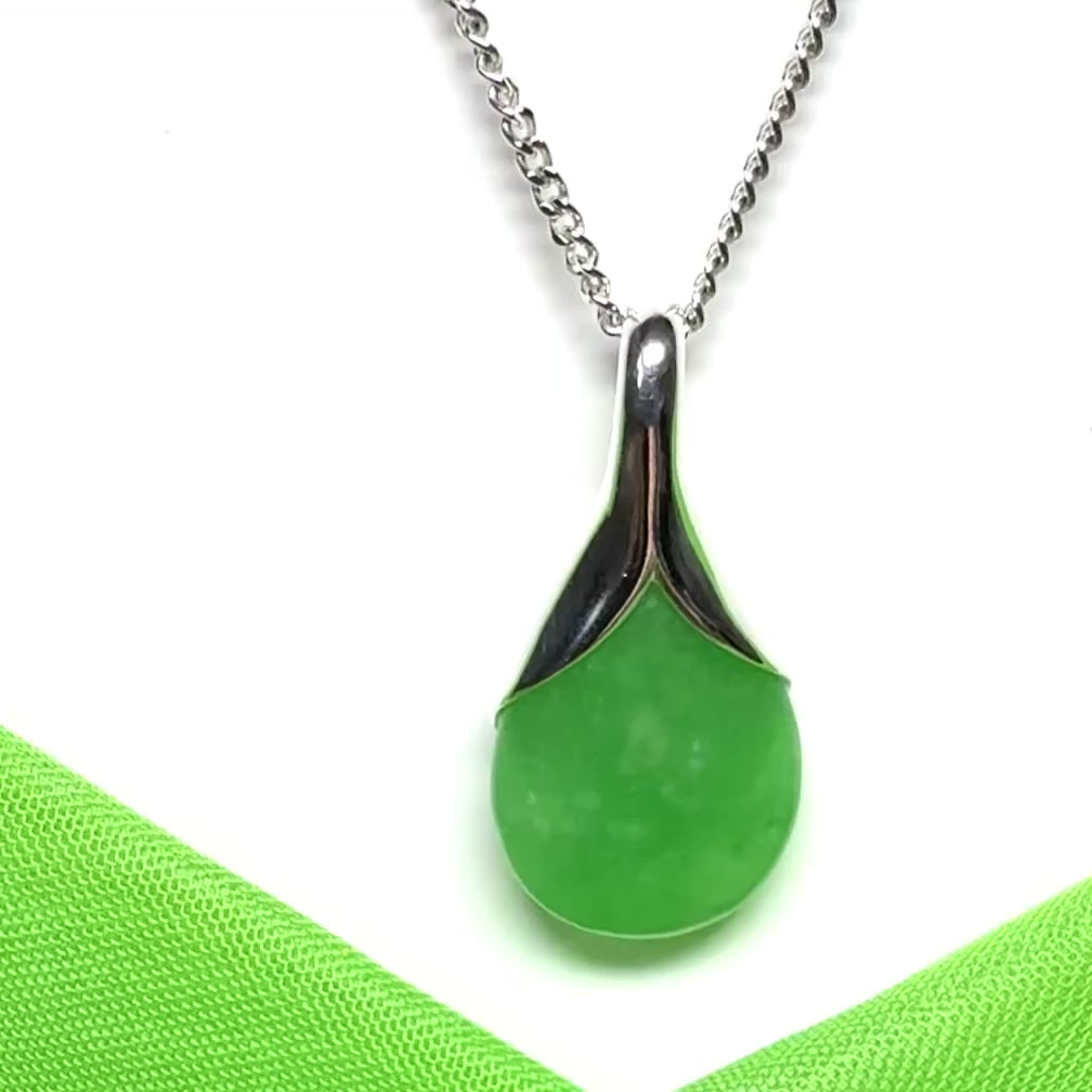 A stunning real green jade necklace in a teardrop or a pear shape including a chain