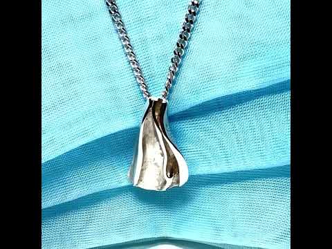 A video of an abstract shaped solid necklace sterling silver pendant