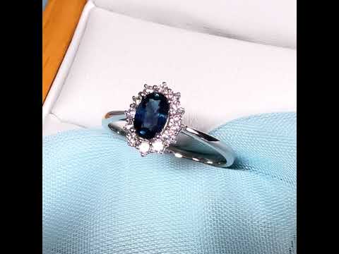 An oval shaped Blue Real Sapphire and Diamond White Gold Cluster Ring
