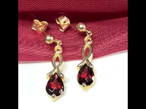 A pair of real red garnet drop earrings pear shaped yellow gold