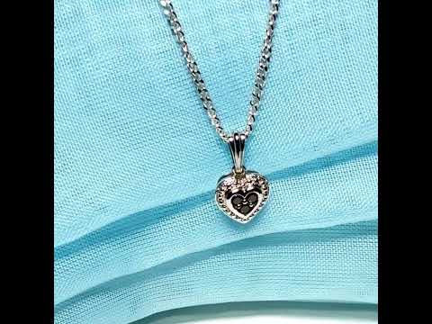 Video of a Real black and white diamond heart shaped white gold necklace pendant