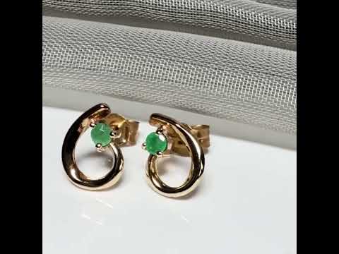 Real emerald pair of stud earrings with a fancy swirl design