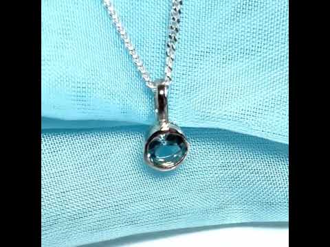 Real blue topaz round sterling silver necklace with a smooth rubbed over pendant
