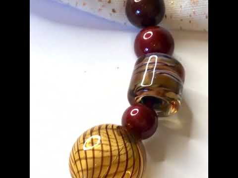 Video of a beautiful brown, white, golden and black beaded real Murano glass necklace