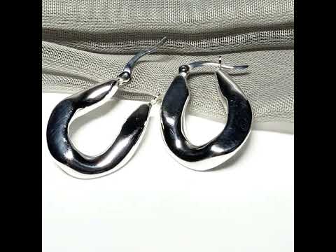 Hoop earrings made in shimmering sterling silver with a fancy twisted design to them