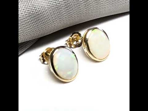 Pair of real opal yellow gold oval stud earrings