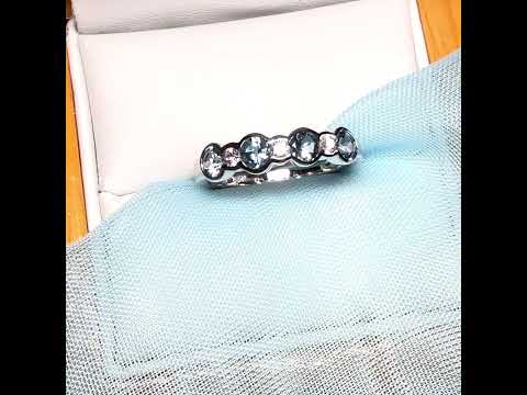 A real aquamarine and diamond white gold eternity ring