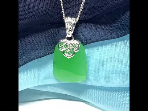 Green real jade necklace with a large shaped and patterned pendant with chain