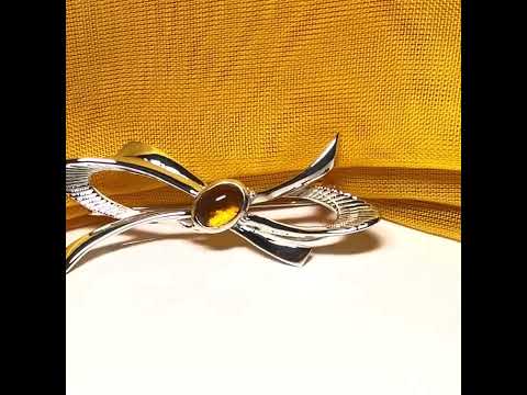 Video of a Bow Shape Sterling silver real amber brooch