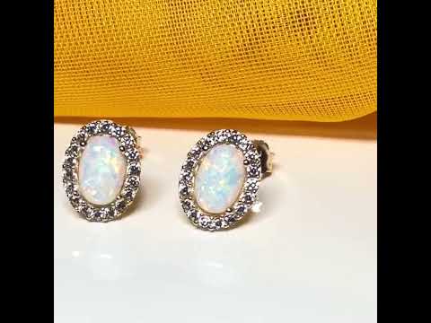 Video of a pair of Oval shaped stud cluster earrings opal and cubic zirconia yellow gold